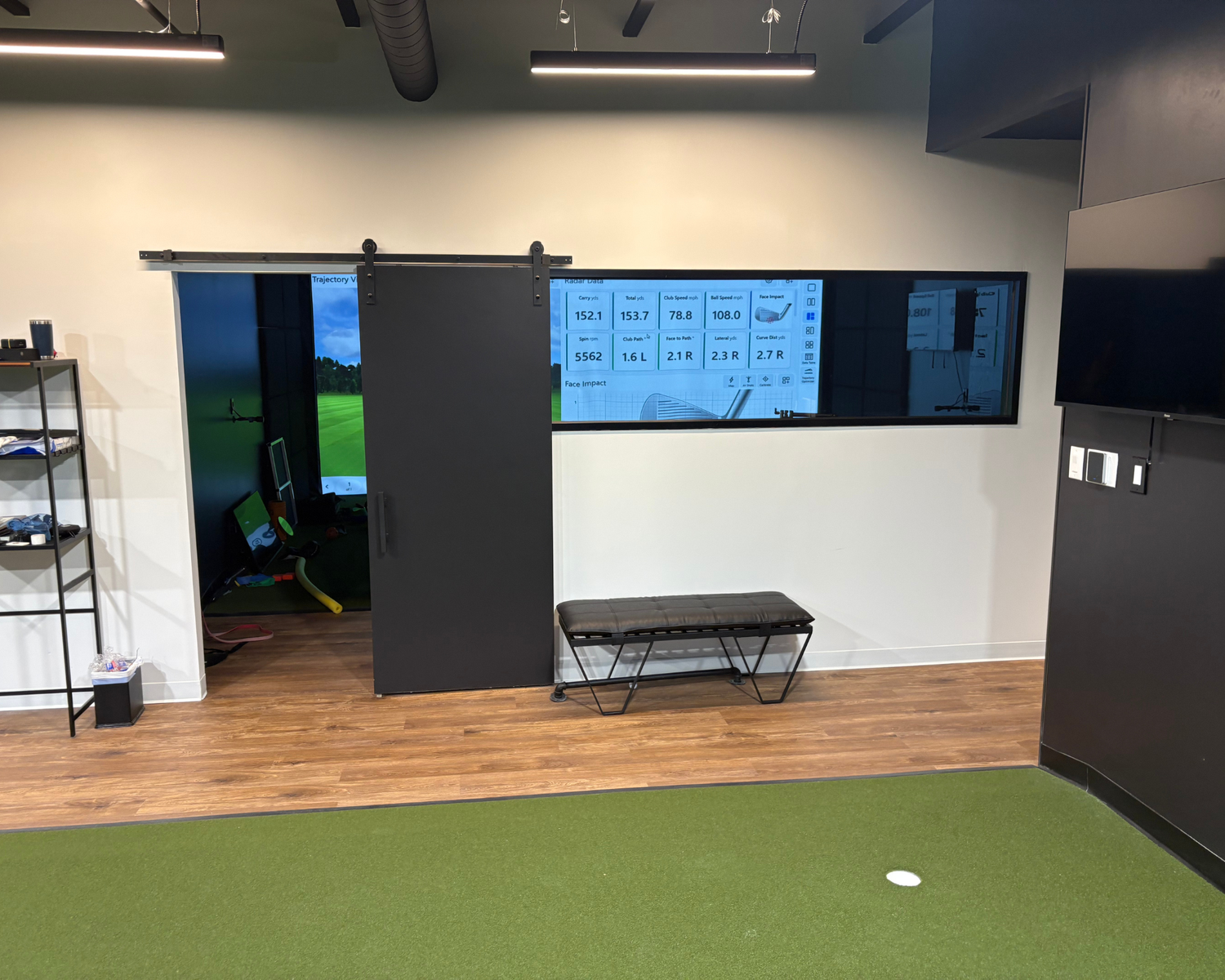 Simulator bay and radar data screen inside the ATX Golf Performance studio on Wild Basin Road in Austin, Texas